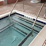 Commercial gunite Hot Tub with white safety grip coping